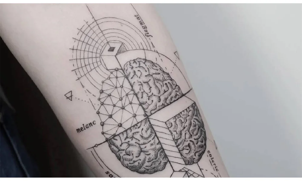 Geometric tattoo on forearm, depicting an abstract brain design with precise lines, patterns, and symmetrical details.