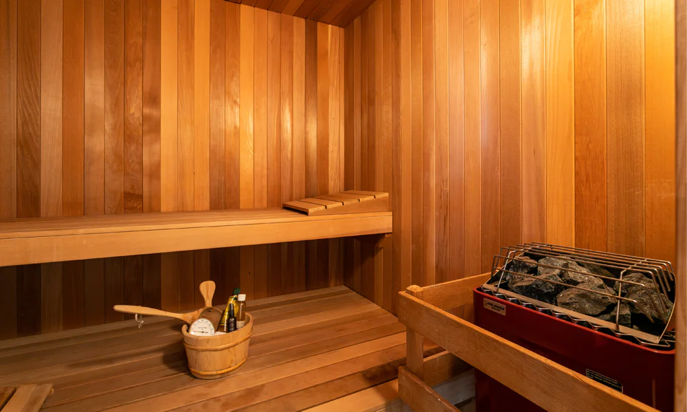 Interior view of a wooden sauna, emphasising the need to avoid excessive heat and steam to protect a healing tattoo.