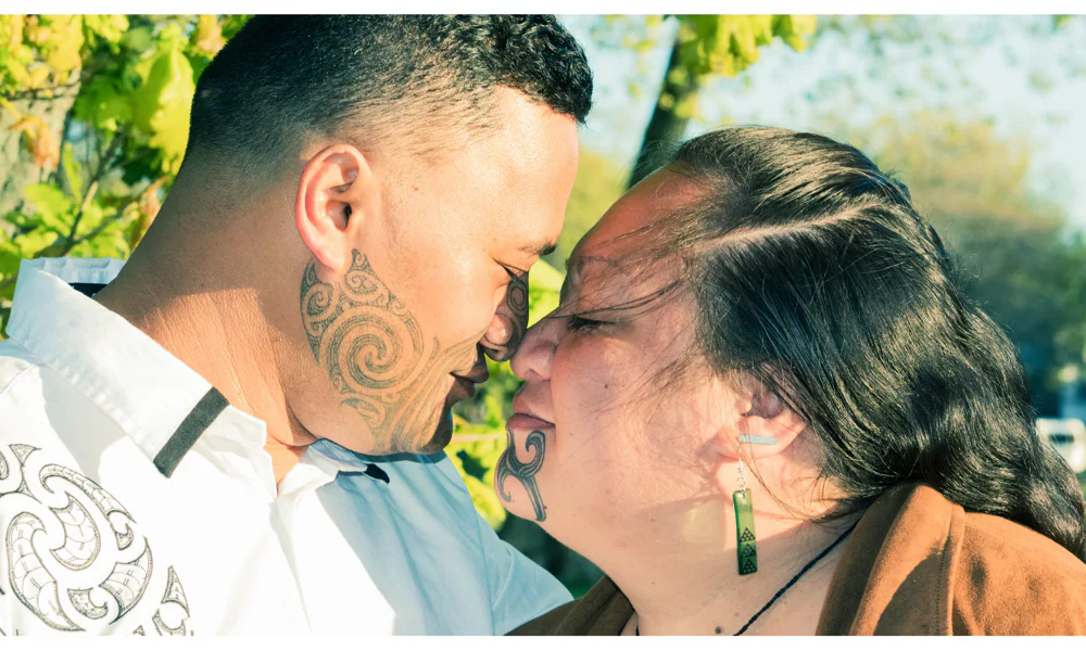 Māori couple with traditional tā moko tattoos, symbolizing heritage and identity