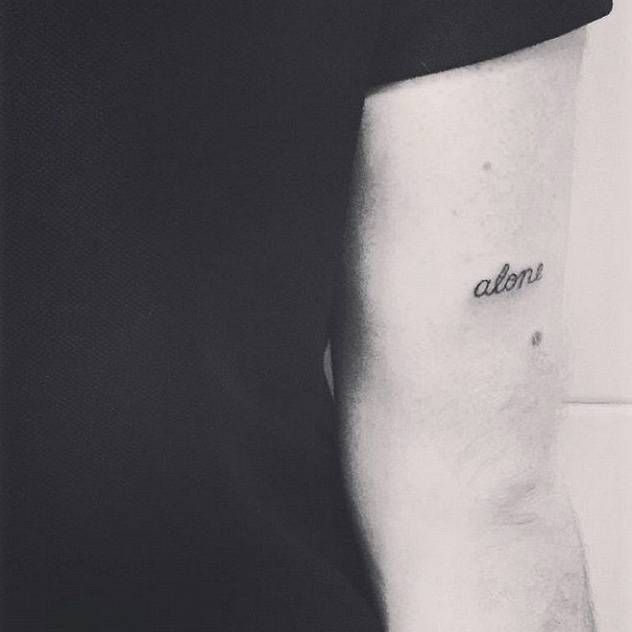 Hand poked “Alone” tattoo on the back of the Sam