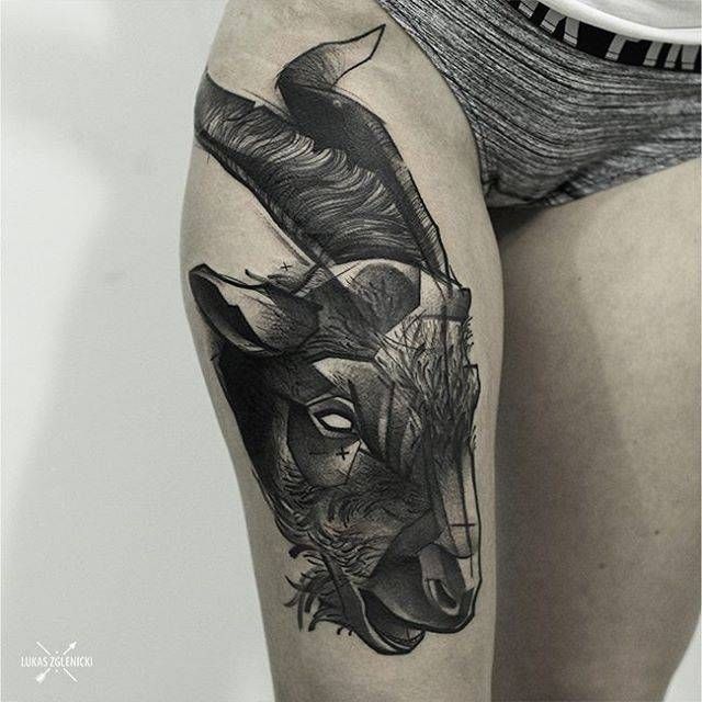 Sketch work goat tattoo on the right thigh.