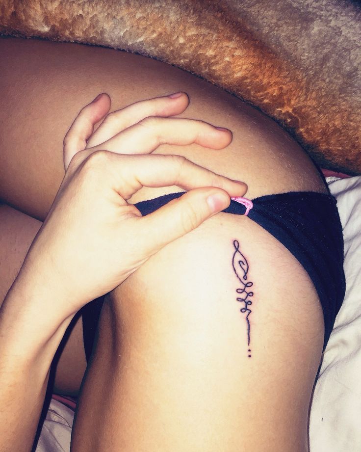 Unalome bikini-line tattoo