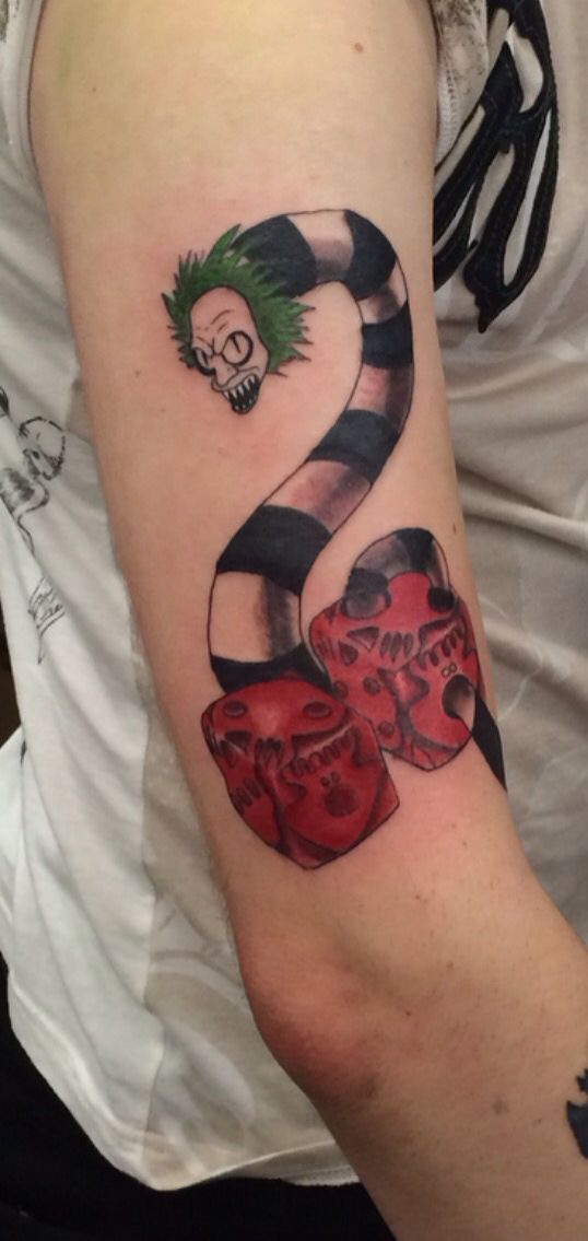 My new tat. Beetlejuice going through Oogie Boogie's dice