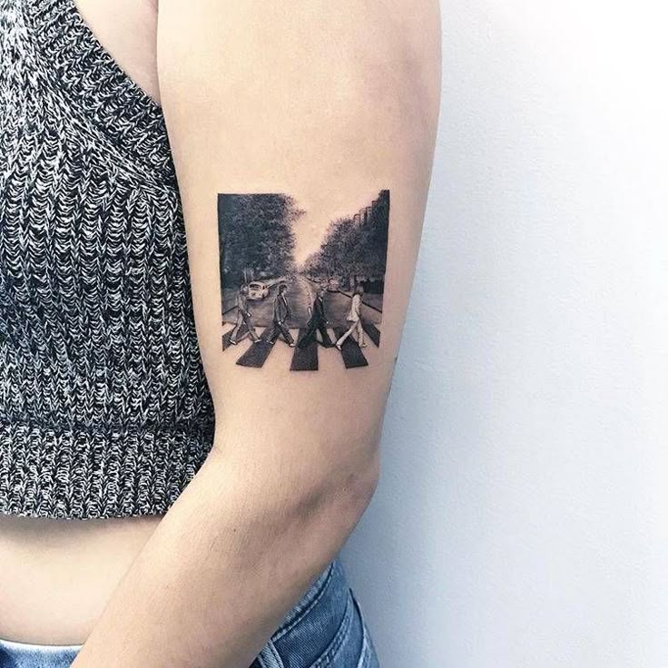 Beatles' Abbey Road cover tattoo on the left upper arm.