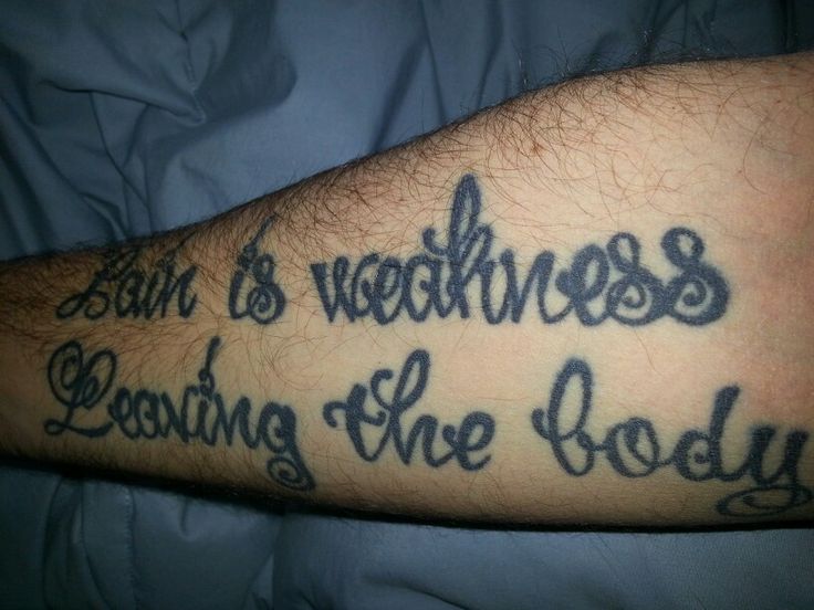 Pain is weakness leaving the body" forearm tattoo