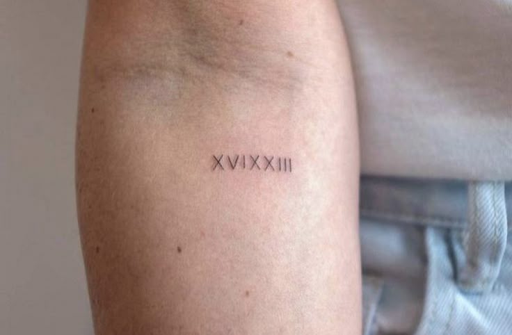 Dainty Roman numeral tatoo