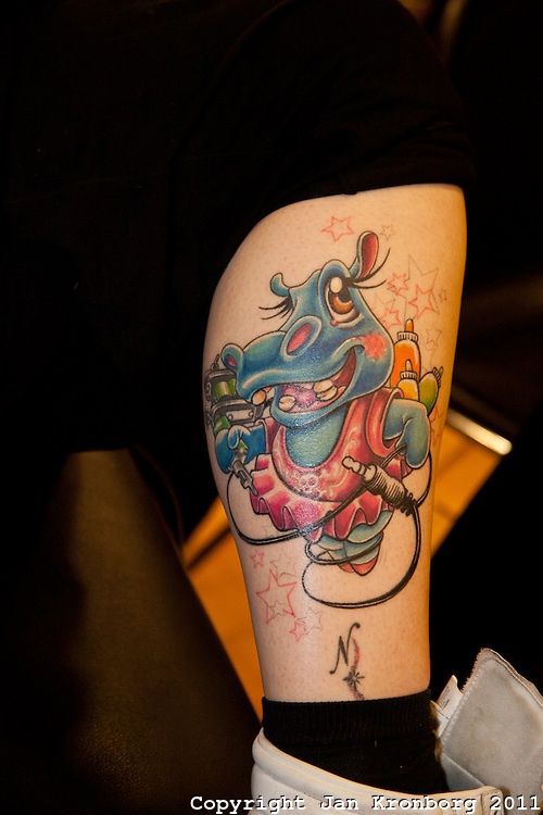 Tattoo Convention in Kolding 2011. Arranged by BodyMod.dk Cartoon hippo  tattoed on calf.