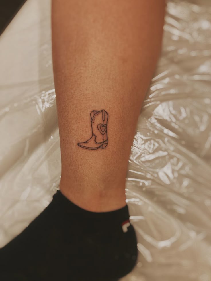 Cowboy boot tattoo - fine line