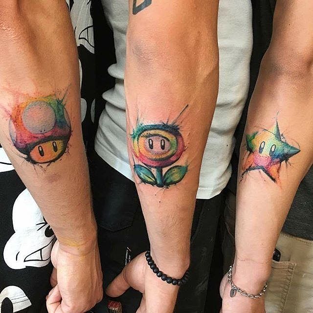 4,116 Likes, 27 Comments - 🏆#1 PAGE ABOUT GAMING TATTOOS! (@gamer.ink) on Instagram: “Watercolor Super Mario Bros tattoos on three brothers done by @tanisbiazus. To submit your work…”