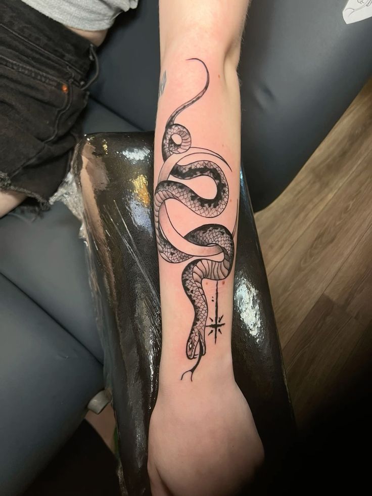 snake arm tattoo for lilith with crescent moon