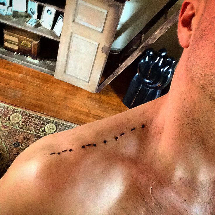Shoulder tattoo "create" in morse code