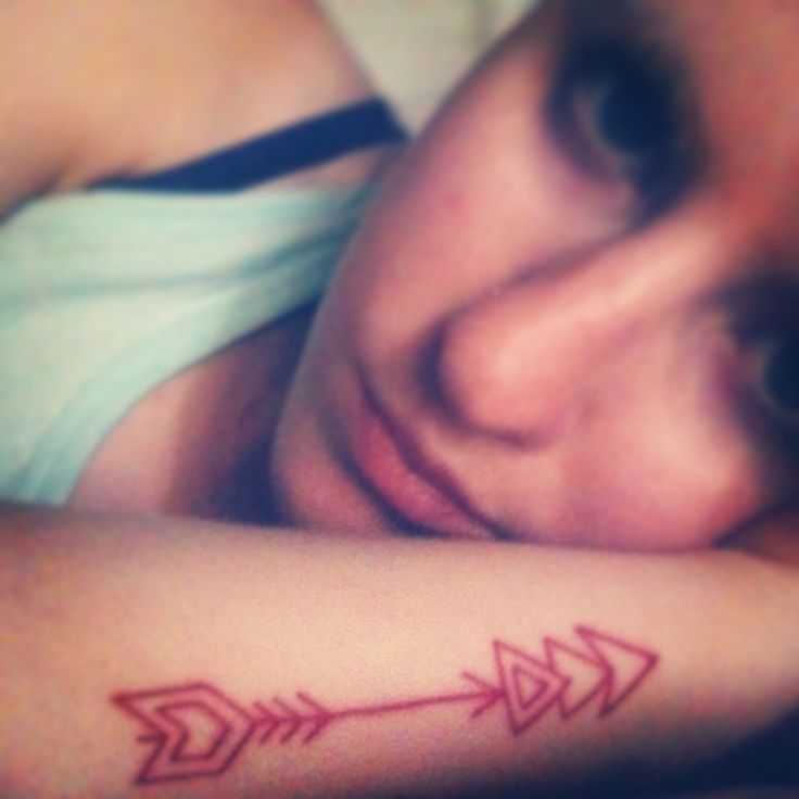 My first Tat! Red ink arrow tattoo :) It represents the reminder to keep moving forward no matter what tries to hold you back. When you shoot an arrow, you have to