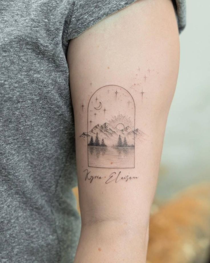 Kyrie eleison and lake landscape tattoo located on the