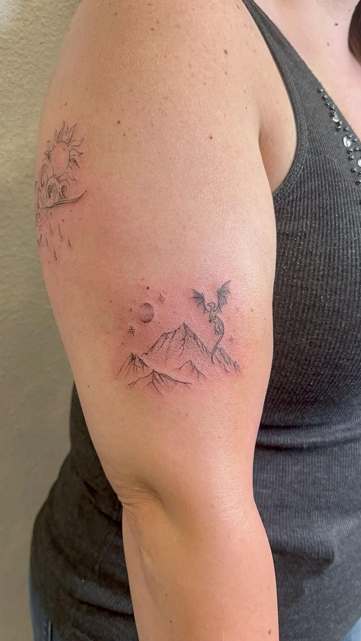 Dragon fine line tattoo with mountain
