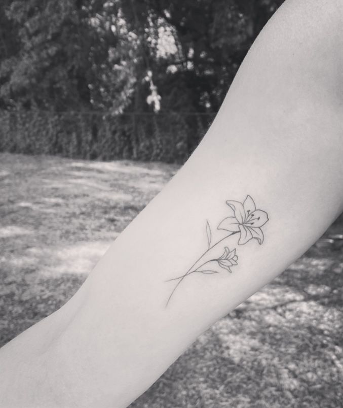 Fine line minimal lily tattoo