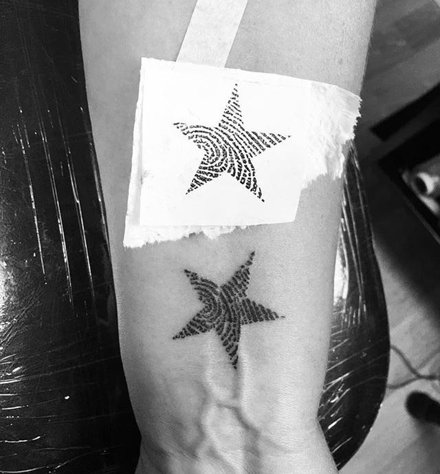 Thumbprint star tattoo