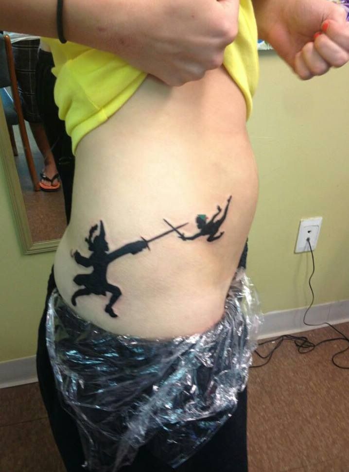 Peter Pan tattoo. This is my first tattoo, it's my adulthood(Captian hook)  and my childhood(Peter pan) battling for dominance. Neither one win neither  one losing.