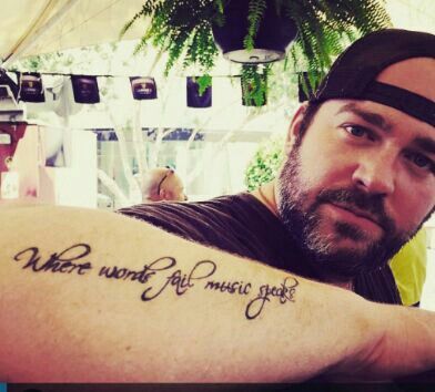 If your like me, and did not know what his tattoo said, here... "Where  words fail music speaks"