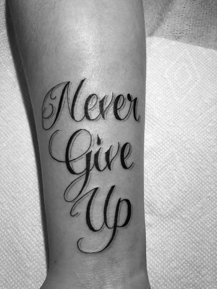 Never Give Up” Walk-In Script Tattoo by Alex Wigley