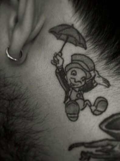 Jiminey Cricket behind the ear tattoo