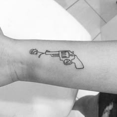 Small gun tattoo