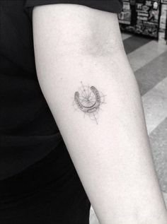 Fine line style horseshoe tattoo on the left inner