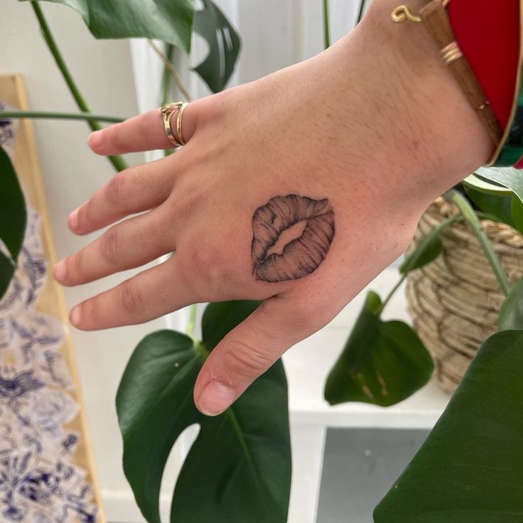 Stunning Kiss Lip Tattoo on the Hand: A Playful Touch
