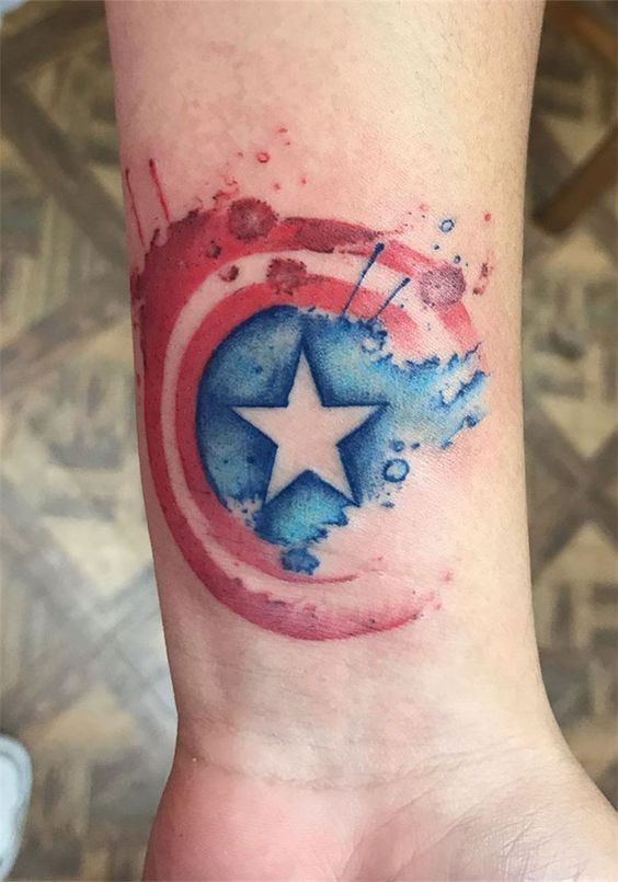 Water colored Captain America tattoo on the wrist | www.otziapp.com