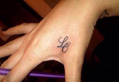 Initial tattoo on hand
